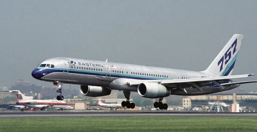 An airplane landing on a runway during the day.